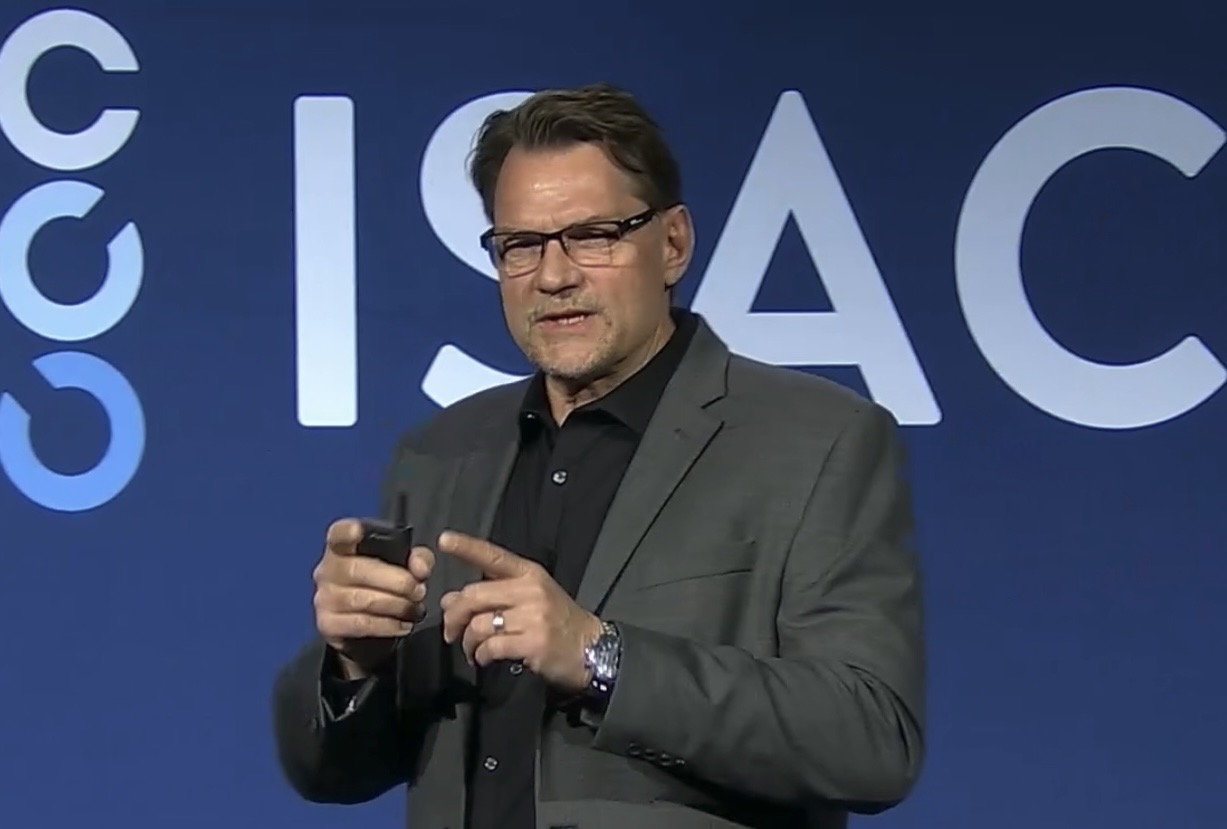 Patrick M. Hayes speaking on stage at an ISACA conference